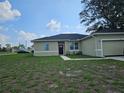 One story house with light beige exterior and a two-car garage at 120 Zinnia W Ln, Kissimmee, FL 34759