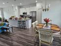 Kitchen and dining area with hardwood floors and white cabinetry at 120 Zinnia W Ln, Kissimmee, FL 34759