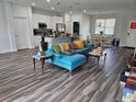 Open concept living room and kitchen with hardwood floors at 120 Zinnia W Ln, Kissimmee, FL 34759