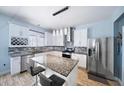 Modern kitchen with white cabinets, granite countertops, and stainless steel appliances at 11932 Old Glory Dr, Orlando, FL 32837