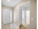 Bright and airy entryway with tile flooring, leading to other rooms at 1352 Water Willow Dr, Groveland, FL 34736