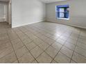 Spacious living room featuring tile flooring and a view of the backyard at 6516 Viewpoint Ct, Orlando, FL 32810