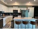 Modern kitchen with white cabinets, stainless steel appliances, and an island with seating at 3141 Paradox Cir # 306, Kissimmee, FL 34746