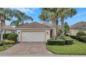 One-story house with a white garage door and landscaped yard at 12203 Pasha Ln, Orlando, FL 32827