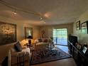 Comfortable living room with a view, hardwood floors, and stylish furniture at 4165 Player Cir # 528, Orlando, FL 32808