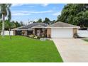 Brick house exterior with a two-car garage and well-maintained lawn at 157 Ambergate Ct, Debary, FL 32713