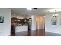Open concept kitchen with island, stainless steel appliances, and dark cabinets at 2652 Carrickton Cir, Orlando, FL 32824