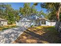 Two-story light blue house with a white garage door and driveway at 4411 White Oak Cir, Kissimmee, FL 34746