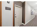 Apartment hallway with modern neutral color scheme at 7573 Laureate Blvd # 1301, Orlando, FL 32827