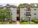 Two-story apartment building with exterior staircase and landscaping at 1932 Lake Atriums Cir # 86, Orlando, FL 32839