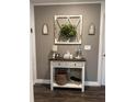Entryway with console table, decor, and hardwood floors at 1908 Piedmont Ct, Mascotte, FL 34753
