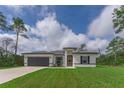 Modern one-story house with a gray garage door and yellow front door at 16988 Sw 25Th Terrace Rd, Ocala, FL 34473