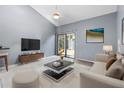 Living room with vaulted ceiling and access to the patio at 101 N Hill Ave # 4, Deland, FL 32724