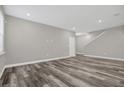Open living area with gray walls and hardwood floors at 1402 Persimmon Ave, Sanford, FL 32771