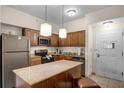 Modern kitchen with stainless steel appliances and granite countertops at 12544 Floridays Resort Dr # 203-B, Orlando, FL 32821