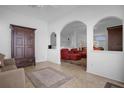 Living room with red couches and a view into the kitchen at 21242 Braveheart Dr, Leesburg, FL 34748