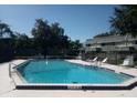 Community pool with surrounding lounge chairs at 525 Conway Rd # 201, Orlando, FL 32807