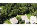 Aerial view showcasing multiple houses nestled in a lush, green wooded area at 276 Tavestock Loop, Winter Springs, FL 32708