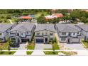 Aerial view of modern homes with a lake and community at 5887 High Seas Dr, Orlando, FL 32821