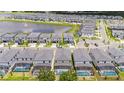Aerial view of a community with a lake and many houses at 5887 High Seas Dr, Orlando, FL 32821