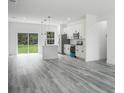 Modern kitchen with white cabinets, stainless steel appliances, and a large island at 602 Marion Oaks Blvd, Ocala, FL 34473
