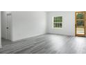 Bright living room with gray vinyl plank flooring and an abundance of natural light at 602 Marion Oaks Blvd, Ocala, FL 34473