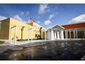 Exterior view of a school building with a yellow facade at 5639 Costa Blanca Way, Davenport, FL 33897