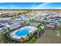 Aerial view of community pool, playground, and residential homes at 5639 Costa Blanca Way, Davenport, FL 33897