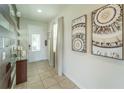 Bright entryway with wood-look wall and glass-top console table at 7432 Marker Ave, Kissimmee, FL 34747
