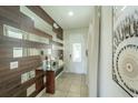 Bright entryway with wood-look wall and glass-top console table at 7432 Marker Ave, Kissimmee, FL 34747