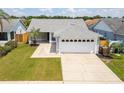 Cute one-story home with a two-car garage and well-manicured lawn at 4704 Cheyenne Point Trl, Kissimmee, FL 34746