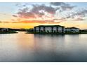 Lakefront community with sunset view and apartment buildings at 8125 Surf St, Kissimmee, FL 34747
