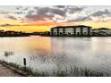 Community lake view at sunset with apartment buildings at 8125 Surf St, Kissimmee, FL 34747