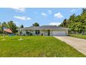 Single-story home with a two-car garage and a large yard at 10604 Se 146Th Ln, Summerfield, FL 34491