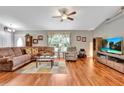 Comfortable living room with hardwood floors and large sectional sofa at 10604 Se 146Th Ln, Summerfield, FL 34491
