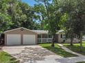 House exterior with two-car garage and front yard at 233 S 4Th St, Lake Mary, FL 32746