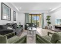 Bright living room with gray sofas, green chairs, and sliding glass doors at 8110 Roseville Rd, Davenport, FL 33896