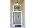 Inviting entryway with a large window and a gray front door at 320 Henley Cir, Davenport, FL 33896