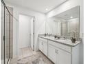 Bathroom with double vanity, granite countertop, and a large shower at 33239 Country House Dr, Sorrento, FL 32776