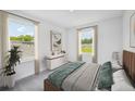 Bedroom with a large bed, two windows, and a dresser at 33239 Country House Dr, Sorrento, FL 32776
