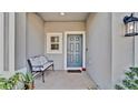 Inviting entryway with bench and front door at 3663 Circle Hook St, Kissimmee, FL 34746
