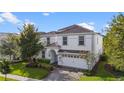 Two-story home with white exterior and gray roof at 1548 Moon Valley Dr, Davenport, FL 33896