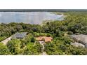 Aerial view of house on lakefront property with lush landscaping and other homes visible at 10611 Jim Edwards Rd, Haines City, FL 33844