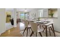 Bright dining area with a modern table and chairs, hardwood floors, and an open concept at 7524 Seurat St # 12301, Orlando, FL 32819