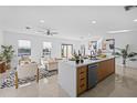 Open concept kitchen with island, modern cabinetry, and stainless steel appliances at 6311 Chorus Dr, Mascotte, FL 34753