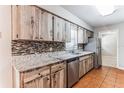 Kitchen boasts granite countertops and wood cabinets at 4913 Se 32Nd Ct, Ocala, FL 34480