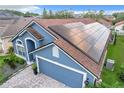 Blue house with solar panels on roof, viewed from above at 13333 Early Frost Cir, Orlando, FL 32828