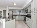 Renovated kitchen with stainless steel appliances and granite counters at 1913 South Blvd, Maitland, FL 32751