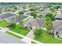 Aerial view of a single story home with landscaped yard and brick driveway at 434 Millwood Pl, Winter Garden, FL 34787