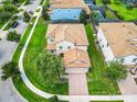 Two story house with tile roof and garage at 1458 Rolling Fairway Dr, Davenport, FL 33896